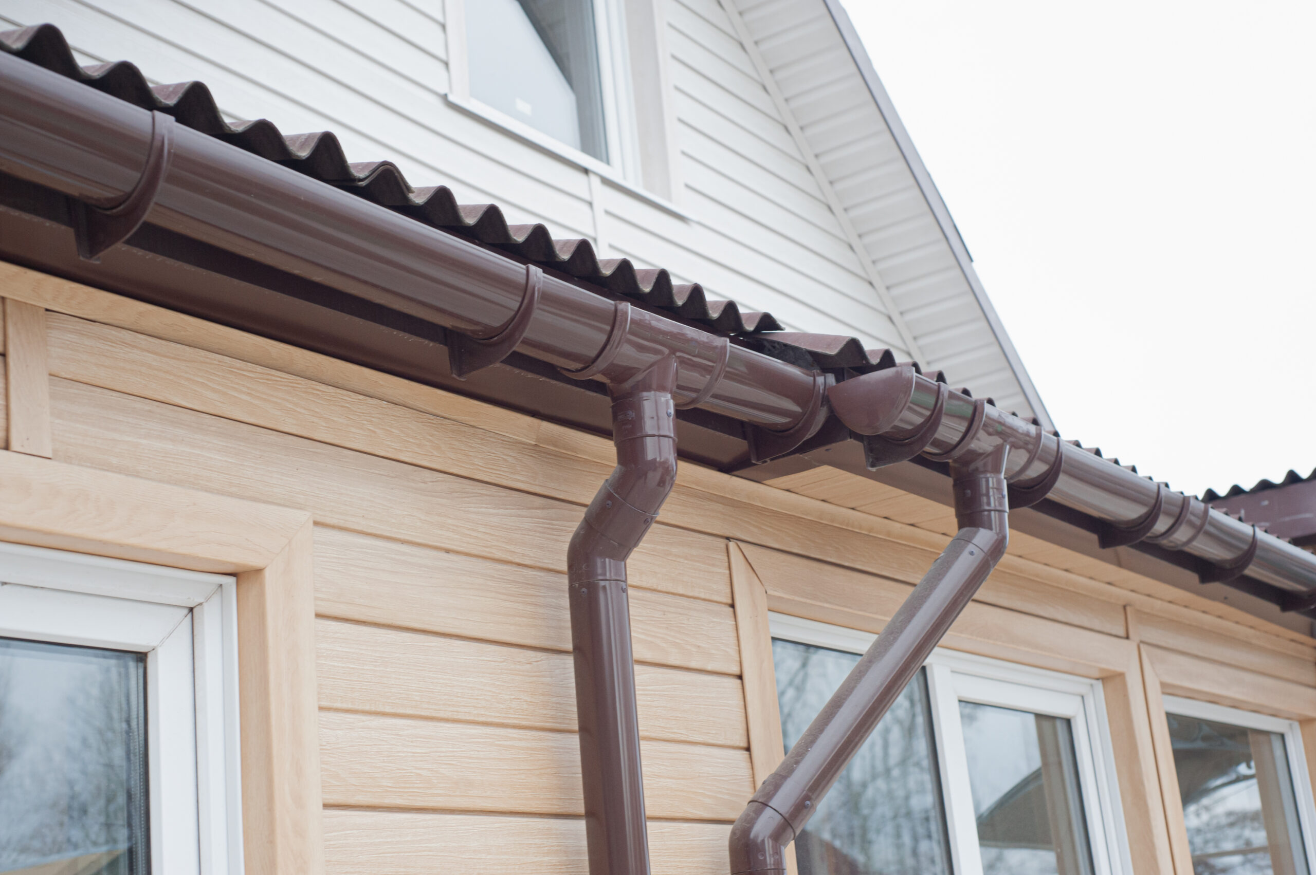 Gutter with downpipe on the roof of a house. zinguerie