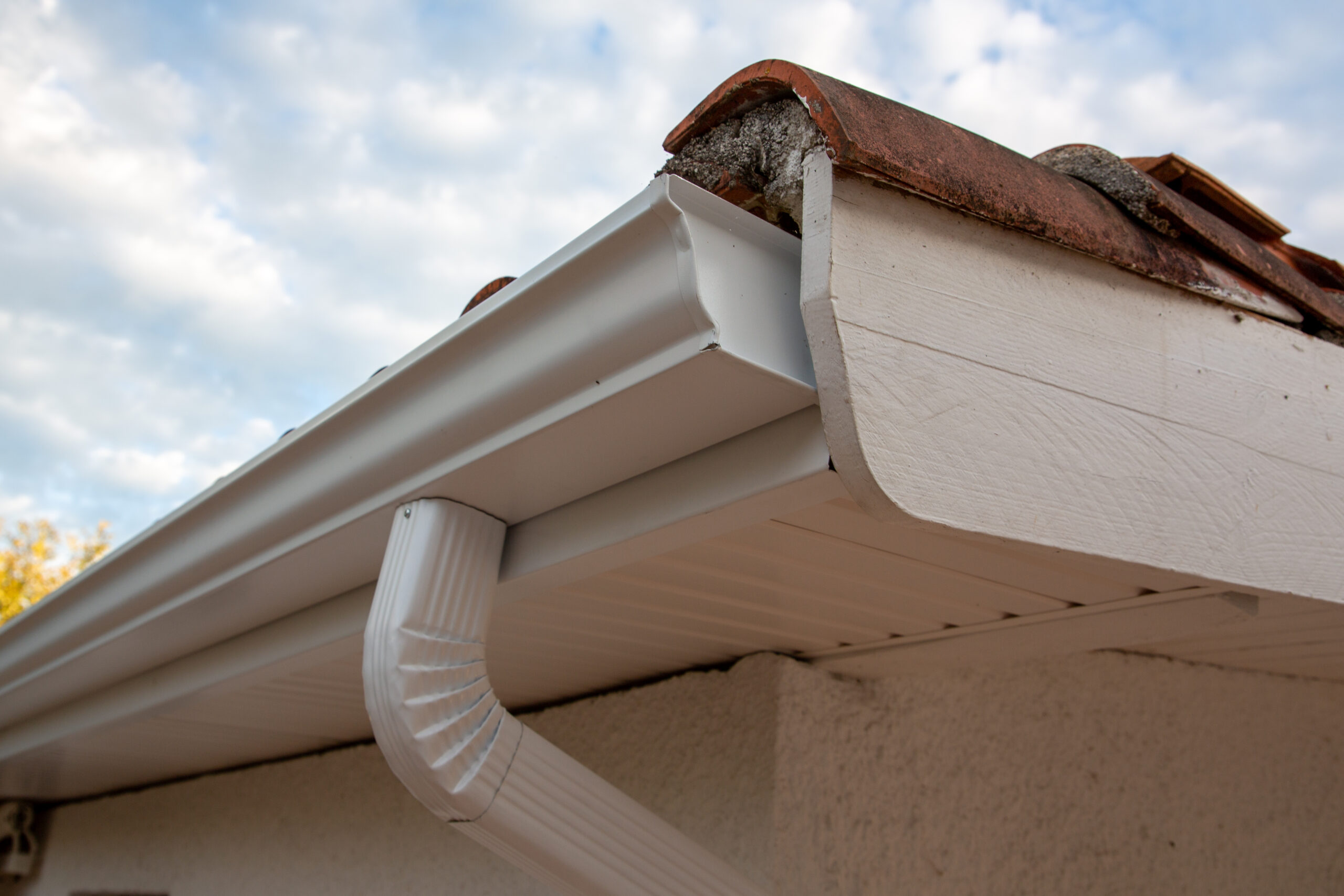 Cleaned white new gutters and drain pipes on restoration house zinc